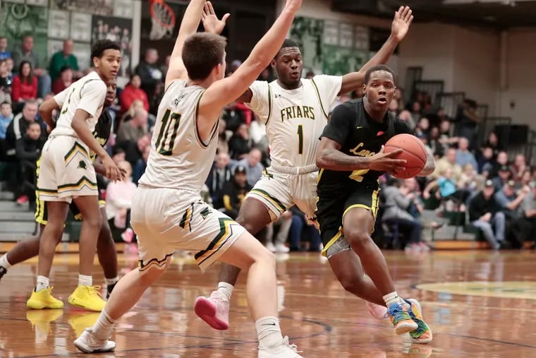 Bishop McDevitt's Robert Smith (right), here driving against Bonner-Prendergast’s Connor Eagan (No. 10) and Cobe Ruley (No. 1), leads the second-seeded Lancers into the Philadelphia Catholic League quarterfinals.