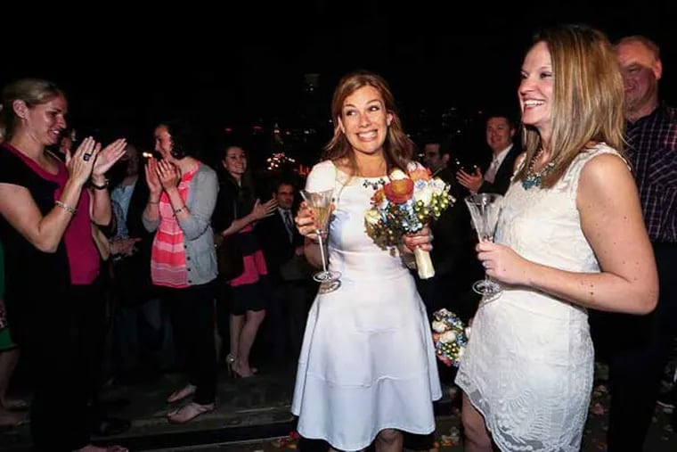 Ashley Wilson and Lindsay Vandermay wed during the first same sex marriage in Philadelphia at the top of the Art Museum steps at 12:01am Friday, May 23, 2014. Court of Common Pleas Judge Diane Louise Anhalt officated the service. (  Steven M. Falk / Staff Photographer )