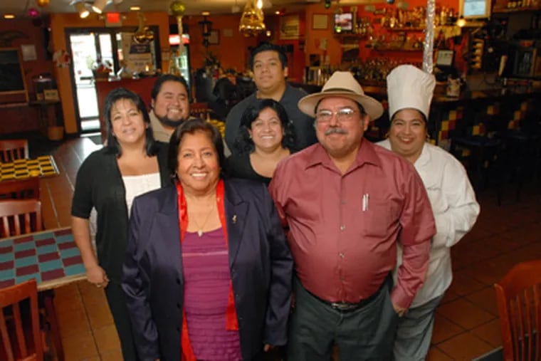 The family Cordova at La Esperanza: Susana and Saul Cordova (front) with (second row, from left) siblings Norma, Saul Jr., Claudia, and Maricela. In back is grandson Oscar Miguel. (April Saul / Staff Photographer)