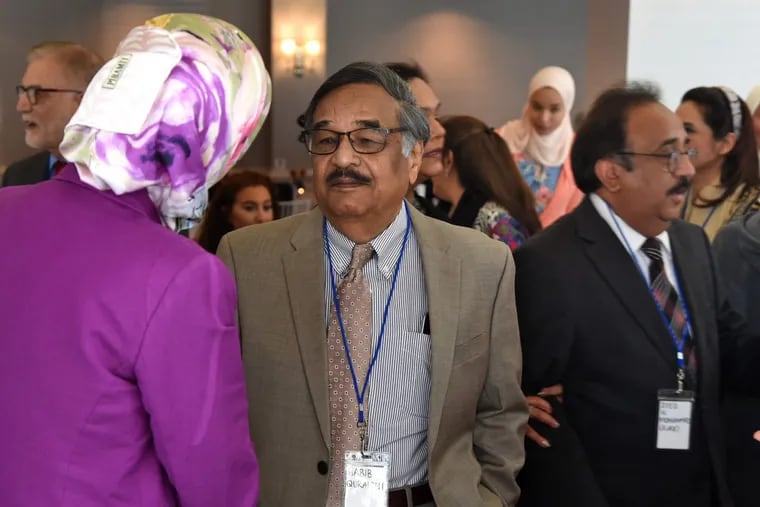 Habib Quarishi (left) and Syed Mohammed (right) greet arriving attendees at the inaugural meeting of the Muslim Federation of South Jersey on Sunday in Cherry Hill.