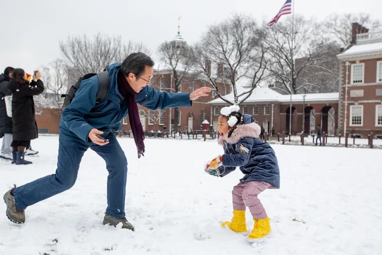 A father and daughter play in the snow on Independence Mall in this 2019 file photo.