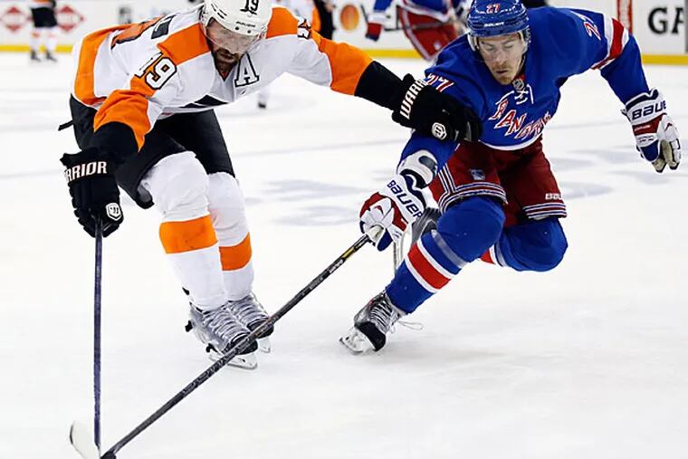 Scott Hartnell goes after the puck against Rangers' Ryan McDonagh. (Yong Kim/Staff Photographer)