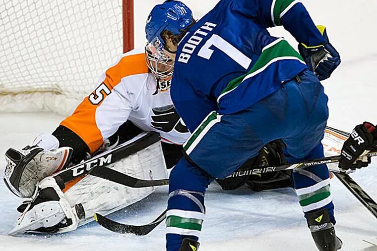 Canucks left wing David Booth tries to get a shot past Flyers goalie Steve Mason during the first period. (Jonathan Hayward/The Canadian Press/AP)