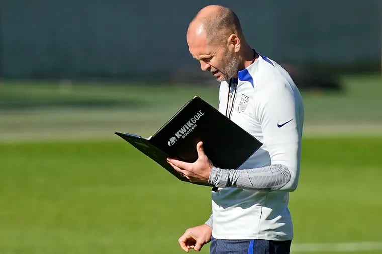 US head coach Gregg Berhalter reads a book during a training session of the US soccer team in Cologne, Germany, prior to a friendly match against Japan, Thursday, Sept. 22, 2022. The USA will play Japan in a friendly soccer match as part of the KIRIN CHALLENGE CUP to prepare for the World Cup in Qatar in Duesseldorf on Friday. (AP Photo/Martin Meissner)