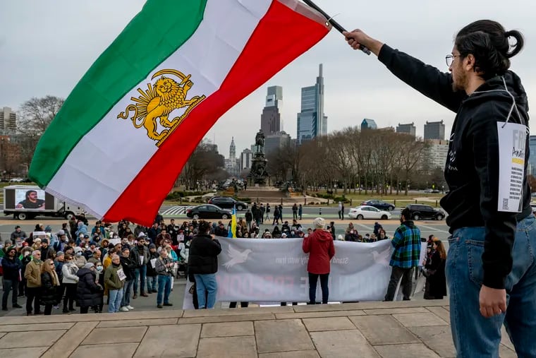 Porya Parsa with Philly Iran waves a large pre-revolution Iranian flag (the lion and sun were replaced with a tulip motif in 1980) during a protest by members of the Philadelphia Iranian community and supporters on the steps of the Museum of Art Sunday, with signs reading "Woman, Life, Freedom" and the names of the victims of Ukrainian Flight PS752 shot down by Iran in 2020 and the” thousands of other victims of the Islamic Republic Regime.” It was part of a worldwide event that also called attention to Russia's invasion of Ukraine and Iran’s supplying of drones and weapons to the Kremlin. The protests escalated after the the death of last fall of 22-year-old Mahsa Amini, who had been in the custody of Iran’s morality police.