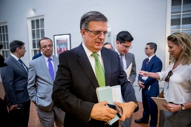 Mexican Foreign Affairs Secretary Marcelo Ebrard, center, departs a news conference at the Mexican Embassy in Washington, Tuesday, June 4, 2019, as part of a Mexican delegation in Washington for talks following trade tariff threats from the Trump Administration. (AP Photo/Andrew Harnik)