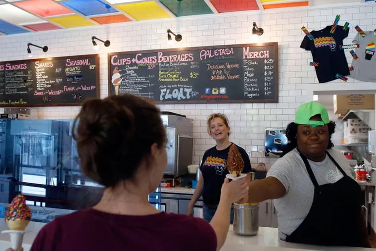 Big Gay Ice Cream manager Janell Avery (right) hands costumer Melissa Nowaczyk (left) ice cream treats with general manager Maureen McCue watching.  ( YONG KIM / Staff Photographer )