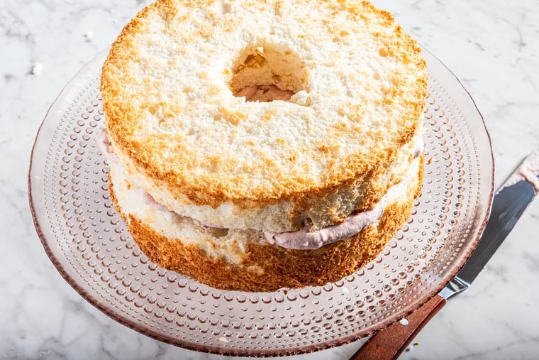 Angel food cake that's been split and filled, but not frosted (yet). MUST CREDIT: Rey Lopez for The Washington Post; food styling by Lisa Cherkasky for The Washington Post