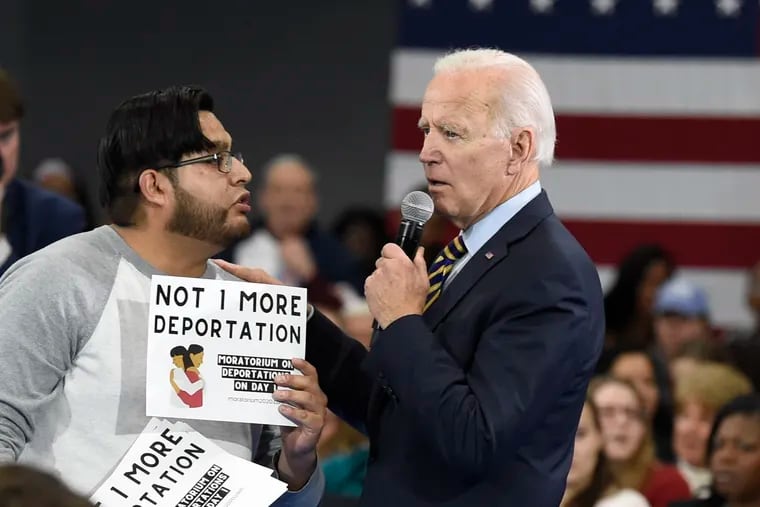 Democratic presidential hopeful Joe Biden talks with protester Carlos Rojas, who objected to Biden's stance on deportations during a town hall at Lander University in Greenwood, S.C., on Nov. 21, 2019.