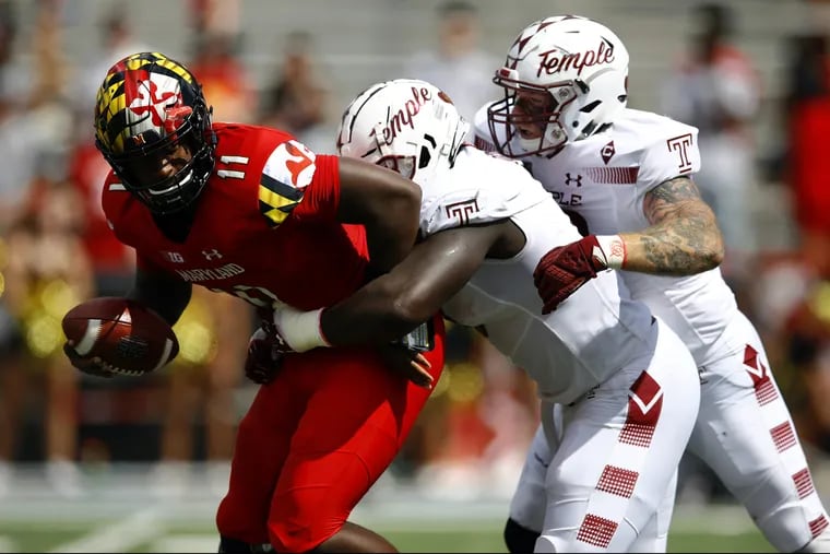 Maryland quarterback Kasim Hill, left, is sacked by Temple defensive tackle Michael Dogbe, center, and defensive end Jimmy Hogan in the first half of an NCAA college football game, Saturday, Sept. 15, 2018, in College Park, Md. (AP Photo/Patrick Semansky)