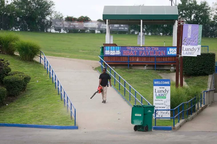 After forty plus people were injured in a mass fall over a wall railing that failed, a BB&T Pavilion employee readies the grounds for a planned concert Saturday August 6, 2016 ( DAVID SWANSON / Staff Photographer )