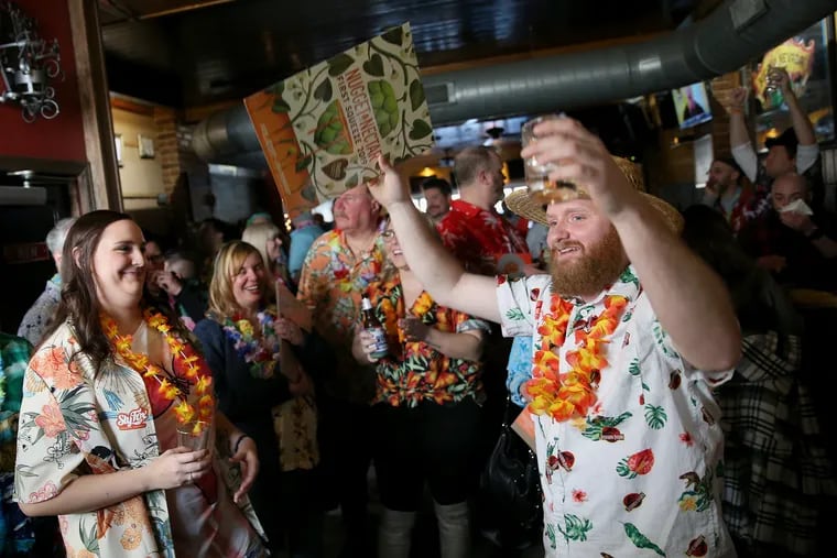 Rocco Pezzano of Philadelphia celebrates winning the crowd's choice in the Hawaiian shirt contest during the annual Groundhog Day event at the Grey Lodge Pub.