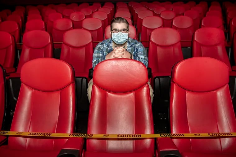 Manager Jimmy Hotham, sits inside a theater with limited seating at the Water Tower Cinema in Lansdale on Friday. The Cinema reopened given virus risks and further-reduced capacity limits.