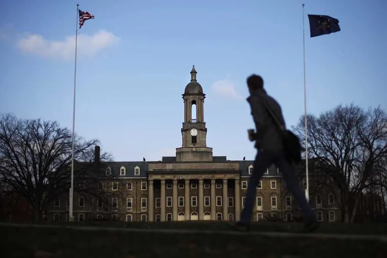 A student walks in front of the Old Main building on the Penn State campus. The university is seeking official rights to the trademark "Happy Valley," which the school has long been known as.