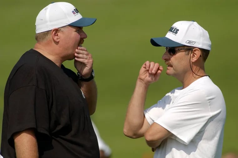 Eagles coach Andy Reid (left) with offensive coordinator Brad Childress during training camp in 2004.