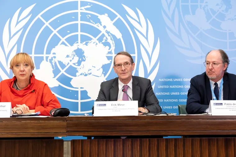 Erik Mose (center) chair of the Commission of Inquiry on Ukraine, and commissioners Jasminka Dzumhur (left) and Pablo de Greiff talk to reporters after an update to the U.N. Human Rights Council.