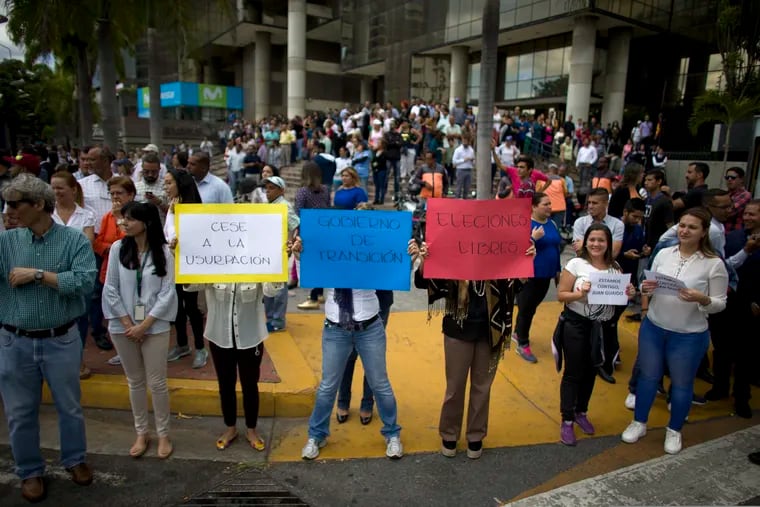 People take part in a walk out against President Nicolas Maduro, in Caracas, Venezuela, Wednesday, Jan. 30, 2019. Venezuelans are exiting their homes and workplaces in a walkout organized by the opposition to demand that Maduro leave power.