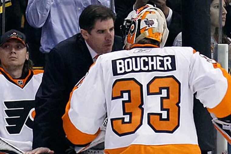 Peter Laviolette talks with Brian Boucher after he allowed two goals in 63 seconds. (Yong Kim/Staff Photographer)