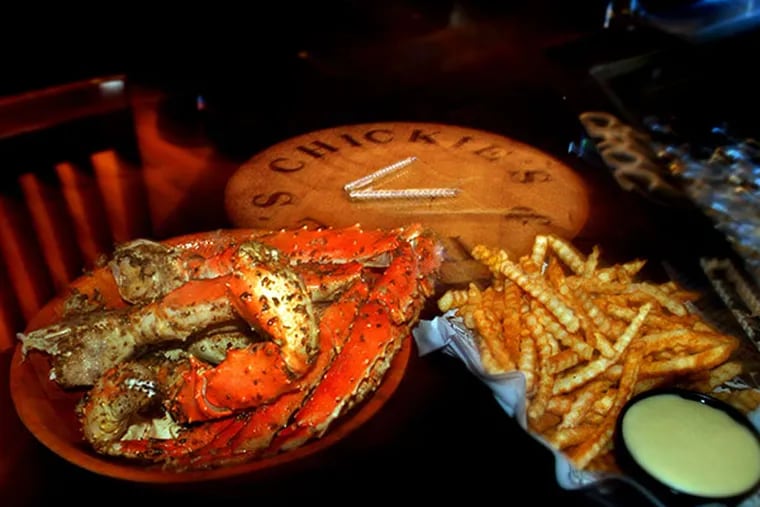 King crab legs and crab fries at the bar of Chickie's and Pete's. (Michael Plunkett/Inquirer File Photo)