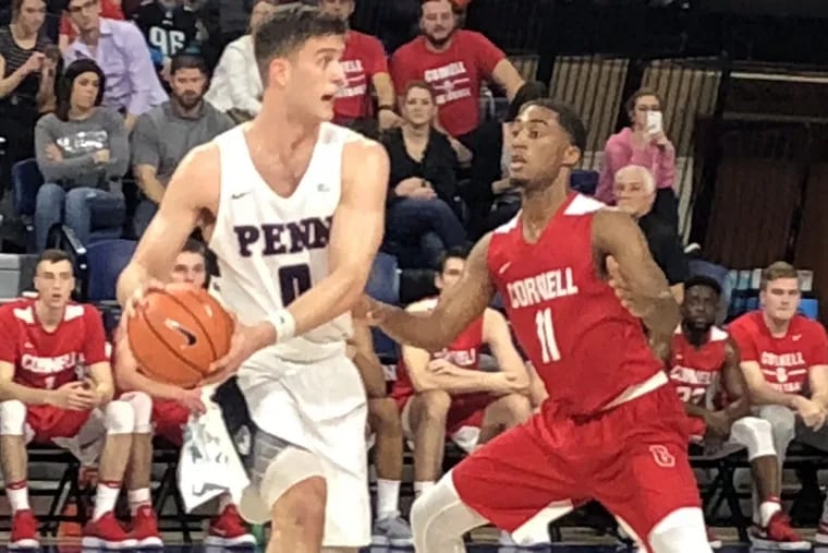Penn’s Max Rothschild looks to pass down low against Cornell’s Terrance McBride. Rothschild had four first half assists