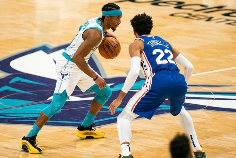 Charlotte Hornets guard Devonte' Graham (4) is defended by 76ers guard Matisse Thybulle.