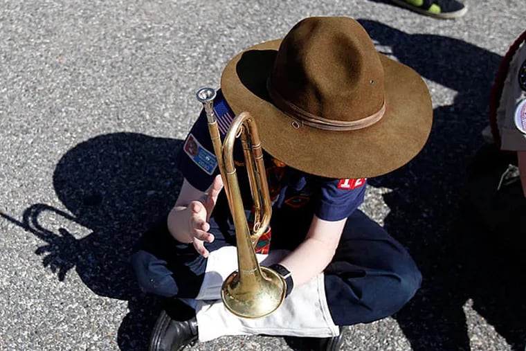 Cub Scout Luke Borkowski (above), of Troop 226, waits with fellow Scouts yesterday before the Bridesburg Memorial Day parade. (David Maialetti/Staff)