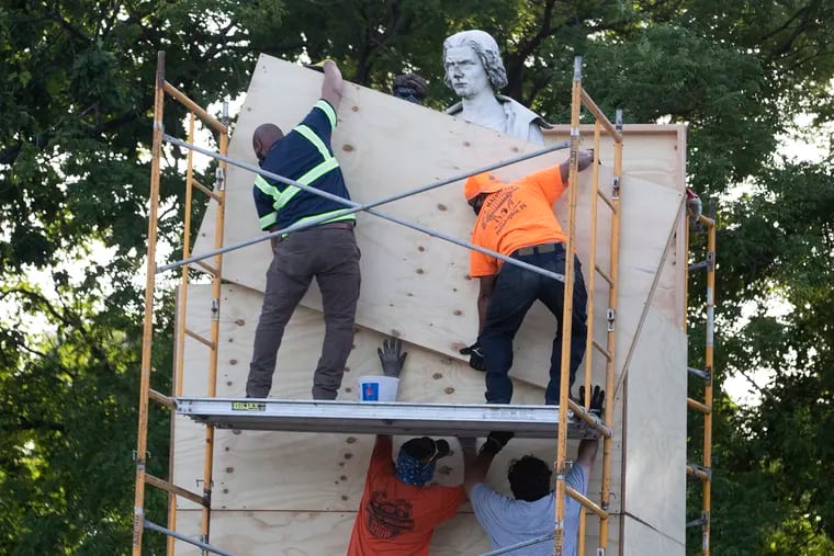 The statue of Christopher Columbus at Marconi Plaza  is enclosed in a box on June 16, 2020, until a decision can be made about its future.