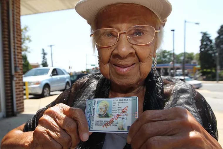 93 year old, Viviette Applewhite holds up the temporary photo id she was able to obtian at the PENNDOT Center at 71st and Olney Ave Thursday afternoon. She wants to be able to vote in the next election so it was very importatn that she obtain her photo id.  Viviette Applewhite goes to PennDot center at 71st and Olney to try to get an ID again.( MICHAEL BRYANT / Staff Photographer )