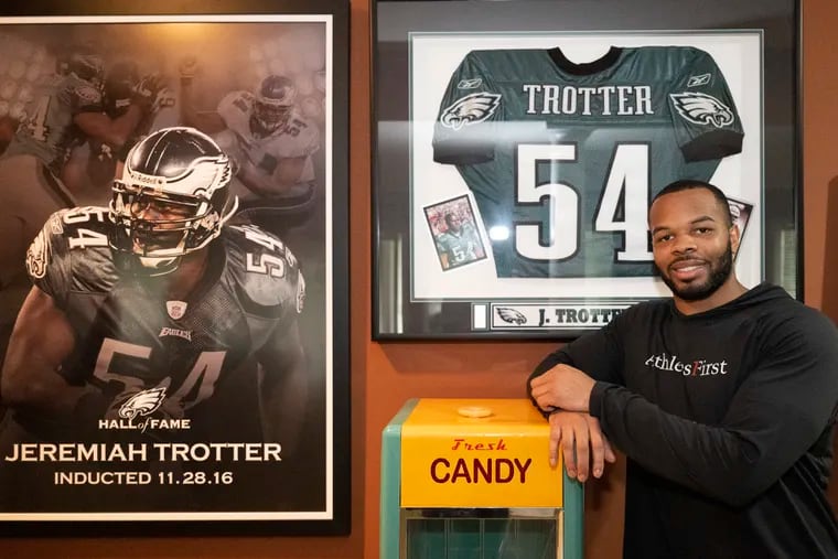 Jeremiah Trotter Jr. is photographed next to his father’s Eagles jersey on Thursday, Apr 11, 2024, during an interview with The Philadelphia Inquirer at his home in Hainesport N.J.