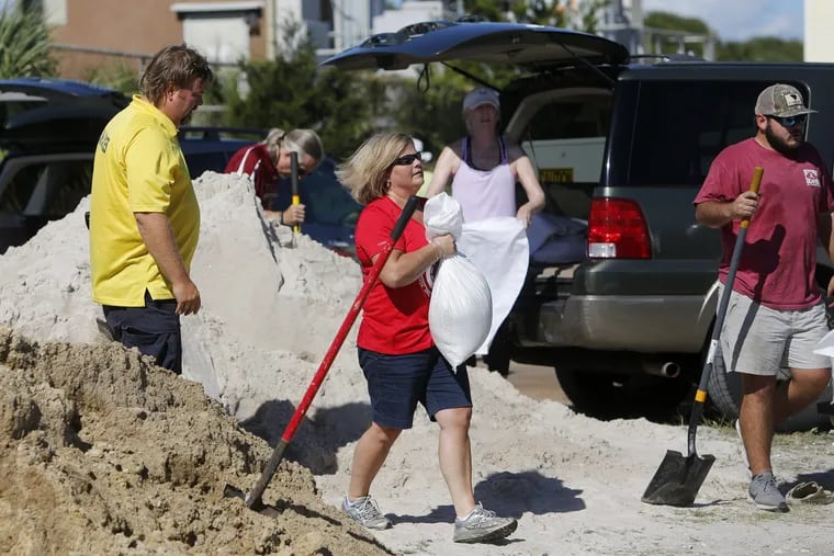 Residents of the Isle of Palms, S.C., fill sand bags at the Isle of Palms municipal lot where the city was giving away free sand in preparation for Hurricane Florence at the Isle of Palms S.C., Monday, Sept. 10, 2018.