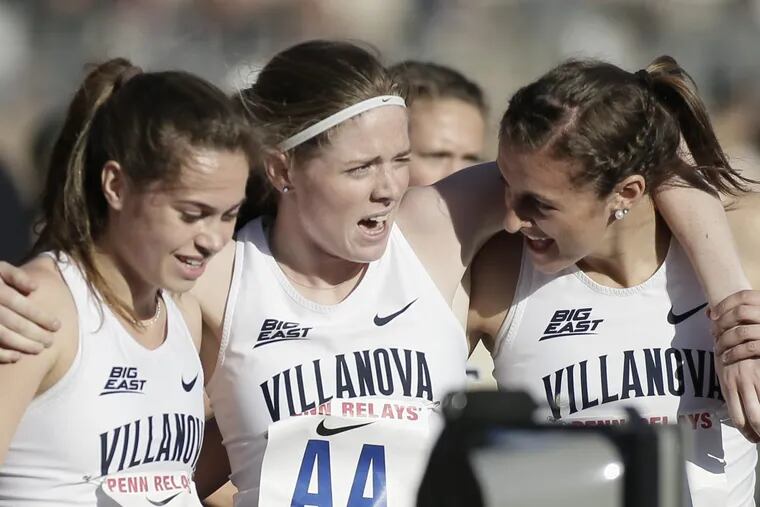 Villanova’s McKenna Keegan, Rachel McArthur and Nicole Hutchinson celebrate together after they won the Penn Relays women’s distance medley Championship of America at Franklin Field.