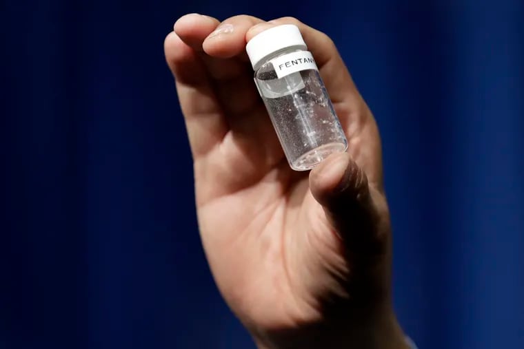 FILE - In this June 6, 2017 file photo, a Drug Enforcement Administration official holds a vial of fentanyl after a news conference about deaths from fentanyl exposure, at DEA Headquarters in Arlington Va.