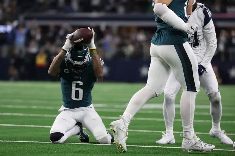 Eagles wide receiver DeVonta Smith gets frustrated and slams the ball after coming up short on fourth down in the third quarter against the Cowboys at AT&T Stadium.