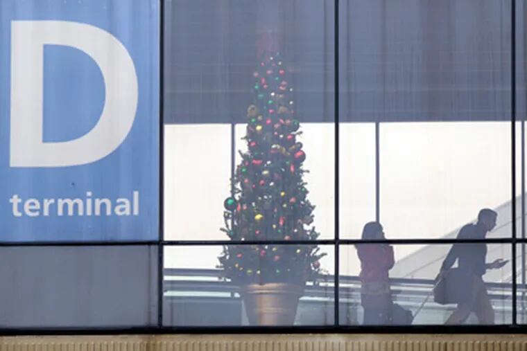Airline travelers head toward the departures teminal at Philadelphia International Airport November 23, 2011. (TOM GRALISH/Staff Photographer )