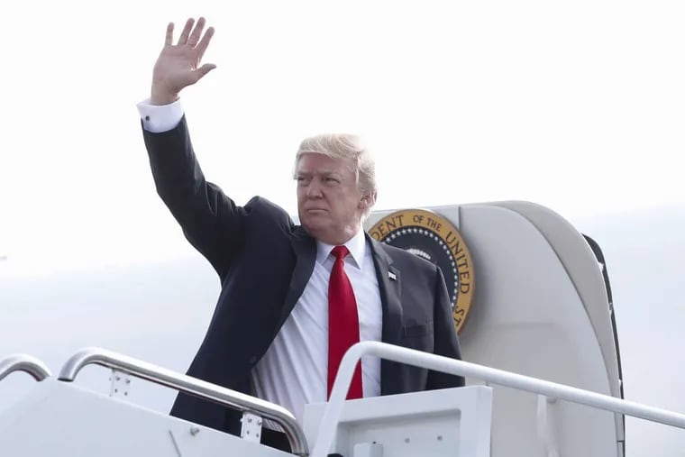 President Donald Trump waves as he boards Air Force One Saturday en route to Naval Air Station Norfolk, in Norfolk, Va.