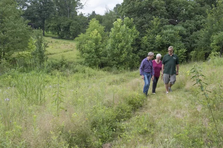 From left, Randy Baum, Sally Baxter, and Karl Flesch walk along a recently created path in Cadwalader Park in Trenton.