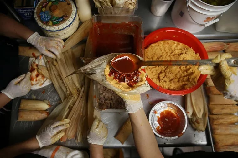 From left, Veronica Guapo, Mari Pilar and Socorro Aparicio make tamales rojos at Tamalex restaurant in South Philadelphia on Friday, April 13, 2018. Each weekend, the restaurant makes about 1100 tamales overnight to sell on Saturday and another 1300 for Sunday. The process can take about eight hours so that the tamales are sold fresh. TIM TAI / Staff Photographer