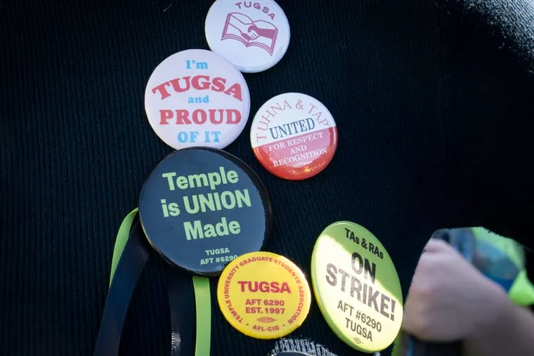 Laura Waters (TUGSA vice president) wears buttons at Temple University during a protest, where students walked out of class in support of striking graduate students on Feb. 15.