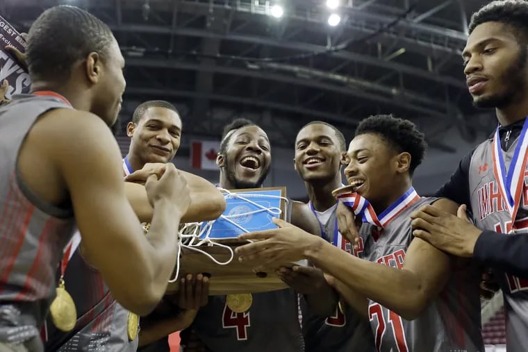 Imhotep Charter players celebrate after beating Sharon, 71-35, for the PIAA Class 4A state basketball championship in March.
