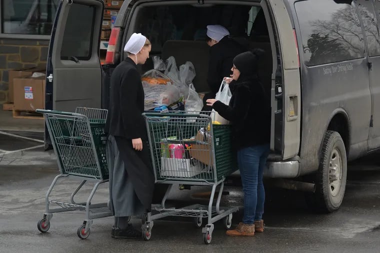 Carrie Shumway, right, who is a driver for the Amish, helps her clients find transportation to food shopping, doctors appointments.