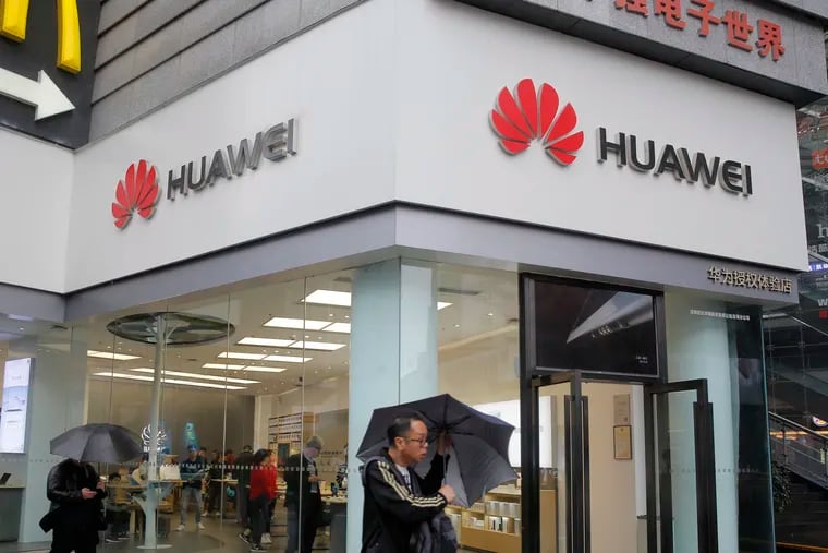 A man walks past a Huawei retail shop in Shenzhen, China's Guangdong province, Thursday, March 7, 2019.