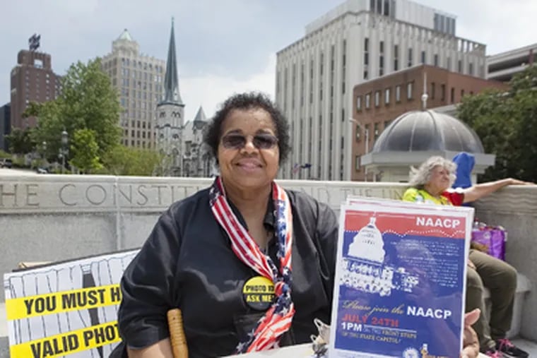 NAACP stages big rally in Harrisburg against the voter ID law on eve of court hearings. Here, Patricia Stringer, 62, of Harrisburg, mans a voter registration table on the Capitol steps. (Ed Hille / Staff Photographer)