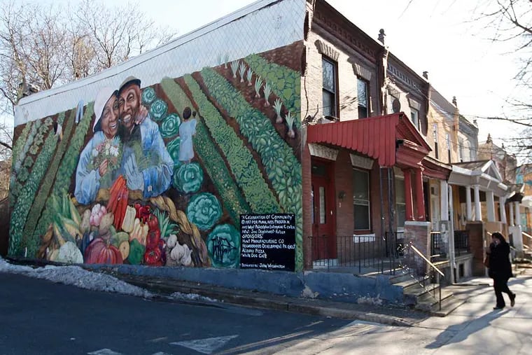 At 44th and Market a row house sports a mural of an elder couple and their city vegetable garden. " ( MICHAEL BRYANT / Staff Photographer )