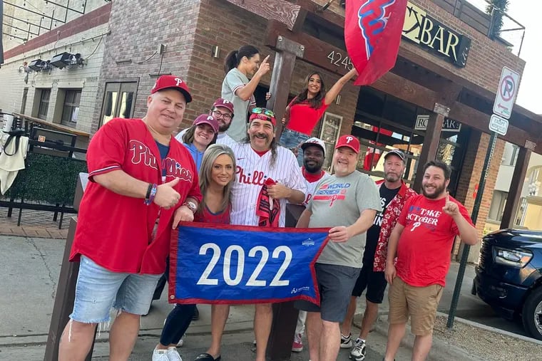 Cherry Hill native Dave Duffy (far left) and "Philly Ray" Poserina (white jersey) pose outside of Rockbar in Scottsdale, Arizona on Thursday.