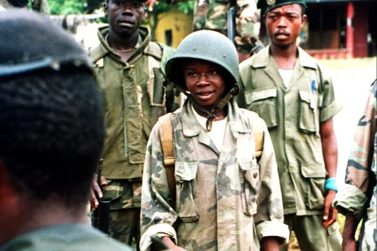 Opening arguments in the trial of Mohammed Jabateh, a Delaware County man accused of lying about his past as a warlord in the Liberian civil wars, are set to begin Tuesday. In this 1992 file photo, a young soldier from the ULIMO militia —  a faction Jabateh fought for in the ’90s — listens to his commanding officer during a briefing of troops.  (Hassan Amini / AP Photo)