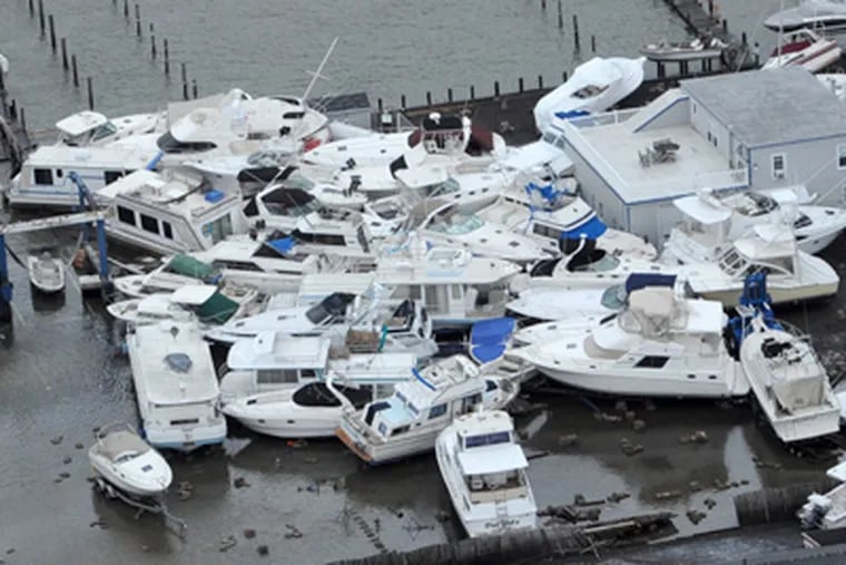 Boats jumbled together at a marina in Brant Beach, on Long Beach Island on the New Jersey Shore on Tuesday, a day after Hurricane Sandy blew across the New Jersey barrier islands. ( CLEM MURRAY / Staff Photographer )