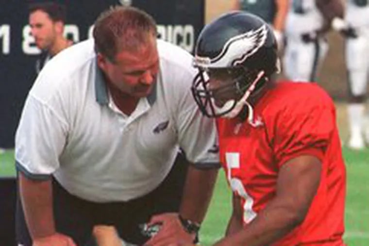 Andy Reid talks to quarterback Donovan McNabb during training camp in 1999, which also was McNabb&#0039;s first with the Eagles. Reid believes tough times laid a foundation for winning.