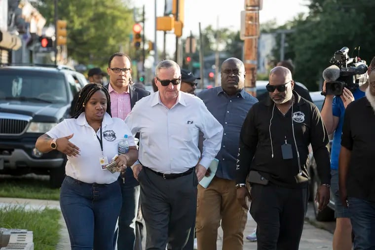 In response to the city's gun violence, Mayor Kenney spent an hour touring Woodland Avenue in Southwest Phiiladelphia on Saturday night. Members of the Philadelphia Anti-Drug, Anti-Violence Network, including Angelic Bradley (left), give the mayor a tour.