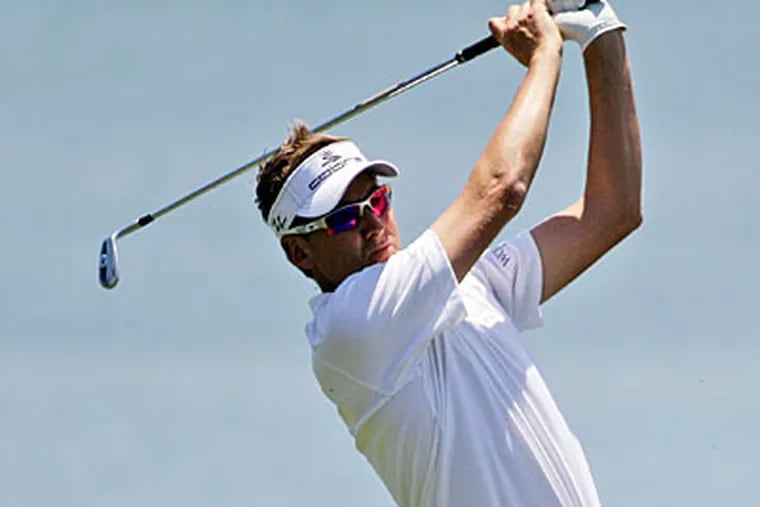 Ian Poulter hits from the 18th fairway during the first round of the Players Championship on Thursday. (John Raoux/AP)