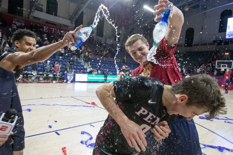 Clark Slajchert (right) of Penn gets  doused with water by George Smith after their victory over Colgate in the Cathedral Classic at The Palestra on Nov. 26, 2022. Slajchert finished with 33 points.
